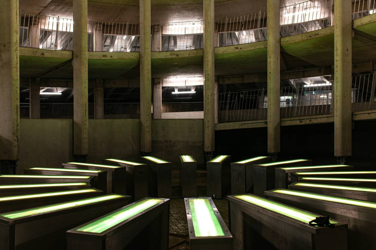 Circular concrete structure with glowing green lights