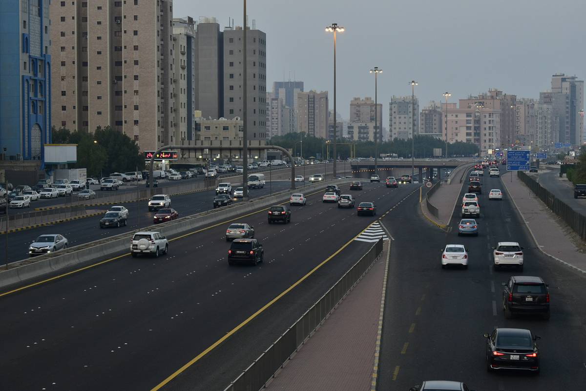 freelancer reviewing gig travel insurance kuwait policy documents on laptop in Kuwait City