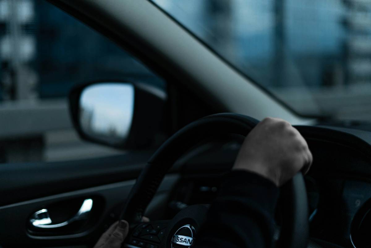 Driving the gig economy: gig worker checking insurance documents in a car abroad